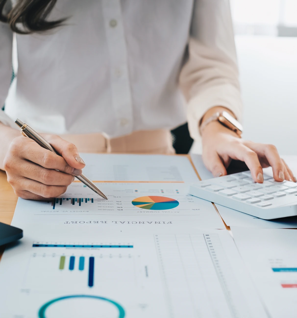Woman reviewing financial documents and graphs